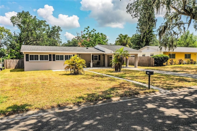 single story home featuring concrete driveway and an attached carport