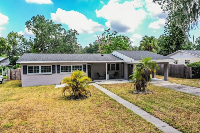 single story home featuring driveway and an attached carport