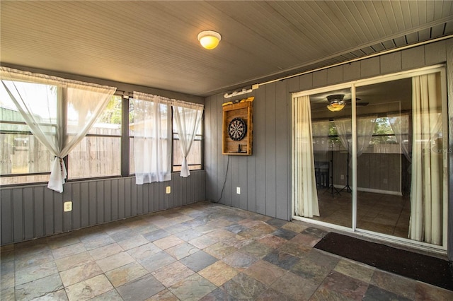 unfurnished sunroom with ceiling fan