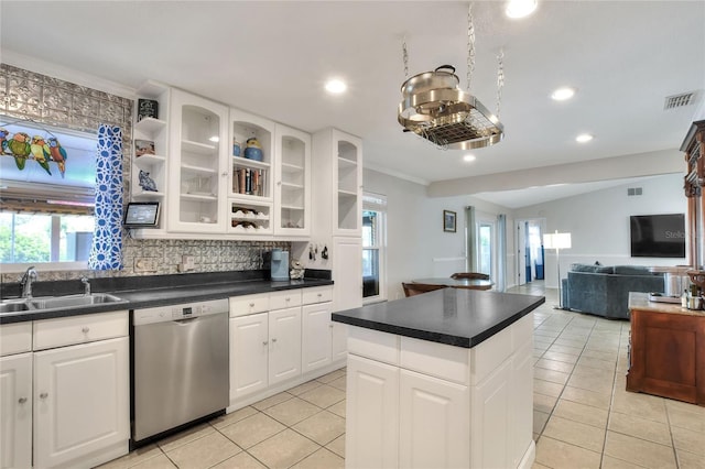 kitchen with dishwasher, a sink, light tile patterned floors, plenty of natural light, and recessed lighting