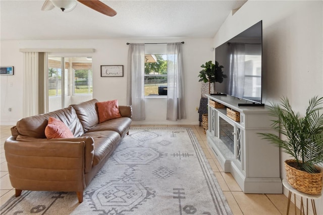 790 Chelsea Way, Lake Wales, FL 33853 - living room featuring light tile patterned flooring, a ceiling fan, and a fireplace with raised hearth