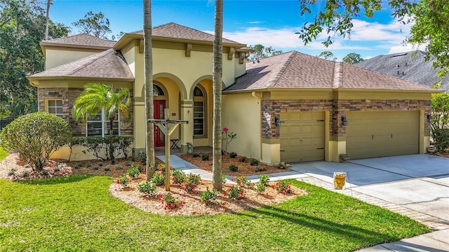 3620 Cordgrass Dr, Valrico, FL 33596 - view of front of home featuring stucco siding, an attached garage, a front lawn, driveway, and stone siding