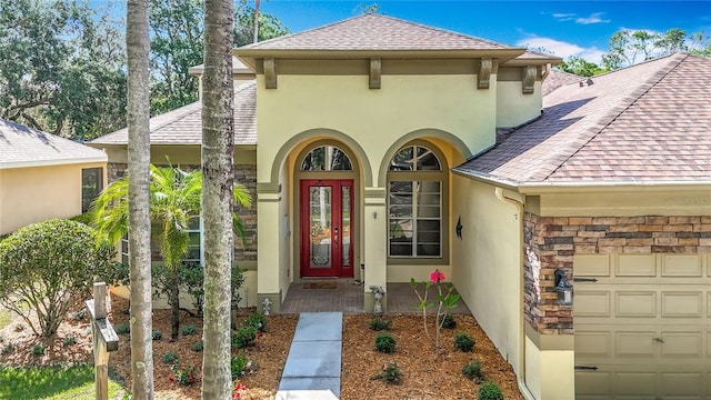 3620 Cordgrass Dr, Valrico, FL 33596 - view of exterior entry with stucco siding, a garage, and a shingled roof