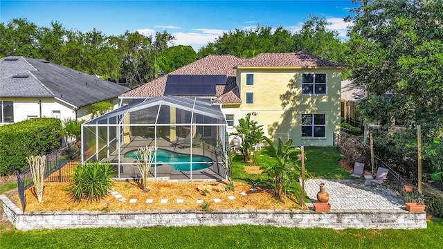 3620 Cordgrass Dr, Valrico, FL 33596 - rear view of property with a patio, stucco siding, a lanai, and solar panels