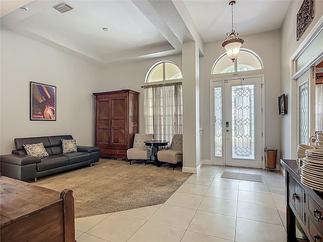 3620 Cordgrass Dr, Valrico, FL 33596 - foyer with light tile patterned flooring, a raised ceiling, a high ceiling, and baseboards