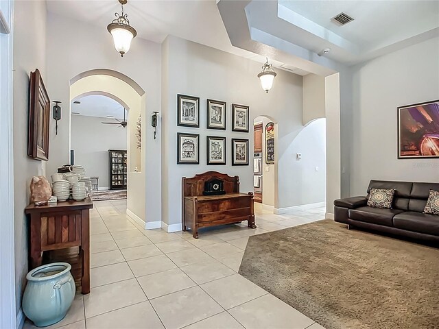 3620 Cordgrass Dr, Valrico, FL 33596 - living area with arched walkways, light tile patterned floors, a ceiling fan, baseboards, and a high ceiling