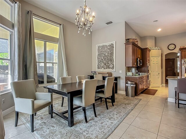 3620 Cordgrass Dr, Valrico, FL 33596 - dining area with plenty of natural light, light tile patterned floors, a chandelier, arched walkways, and recessed lighting
