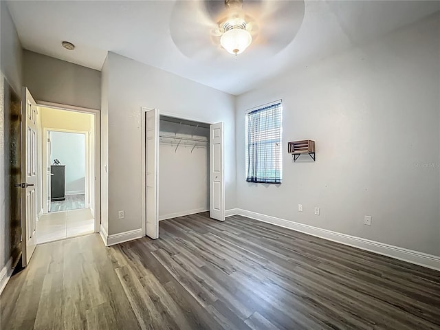 3620 Cordgrass Dr, Valrico, FL 33596 - unfurnished bedroom with wood finished floors, a closet, baseboards, and ceiling fan