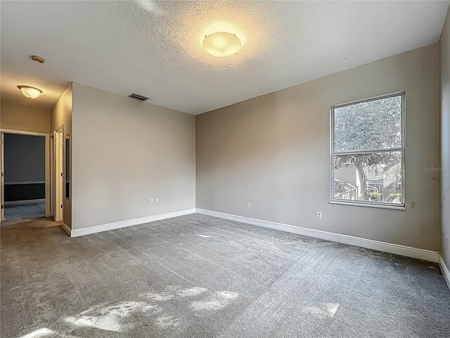 3620 Cordgrass Dr, Valrico, FL 33596 - carpeted empty room with baseboards, a textured ceiling, and a smoke detector