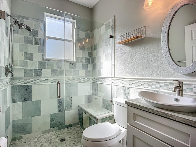 3620 Cordgrass Dr, Valrico, FL 33596 - full bath with tile walls, a stall shower, toilet, vanity, and a textured wall