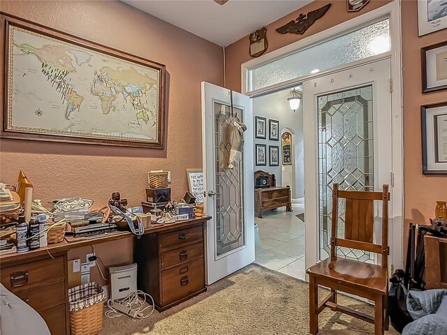 3620 Cordgrass Dr, Valrico, FL 33596 - office with light colored carpet, a textured wall, and light tile patterned flooring