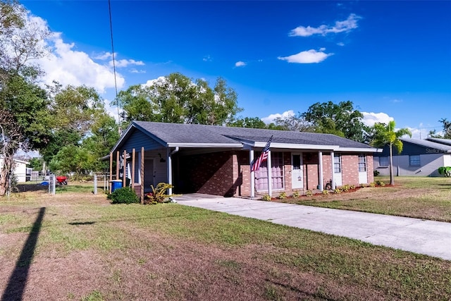 ranch-style house with concrete driveway, a carport, and brick siding