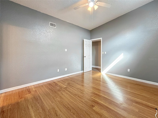 6350 92nd Pl N Unit 2206, Pinellas Park, FL 33782 - empty room featuring a ceiling fan, wood finished floors, a textured ceiling, baseboards, and a textured wall