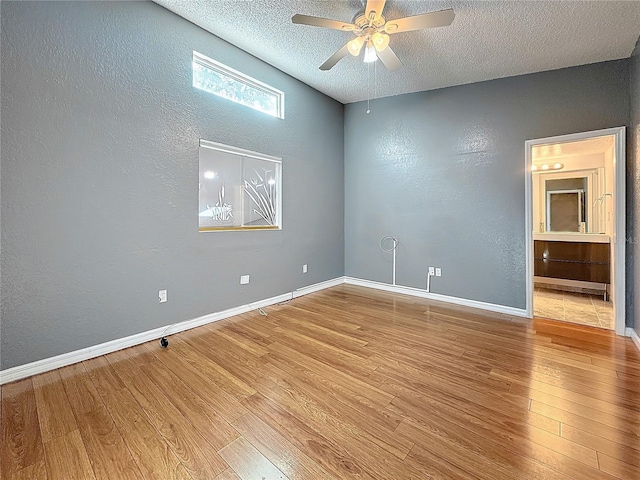6350 92nd Pl N Unit 2206, Pinellas Park, FL 33782 - unfurnished room with a textured wall, a ceiling fan, a textured ceiling, wood finished floors, and baseboards