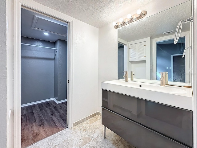 6350 92nd Pl N Unit 2206, Pinellas Park, FL 33782 - bathroom featuring vanity, a textured ceiling, and baseboards