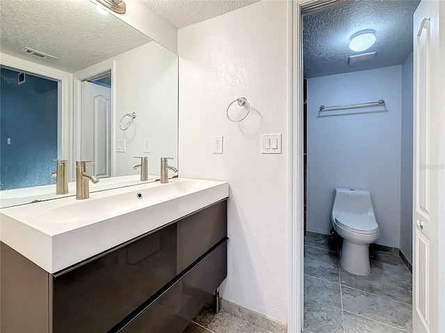 6350 92nd Pl N Unit 2206, Pinellas Park, FL 33782 - bathroom with a textured ceiling, baseboards, vanity, and toilet