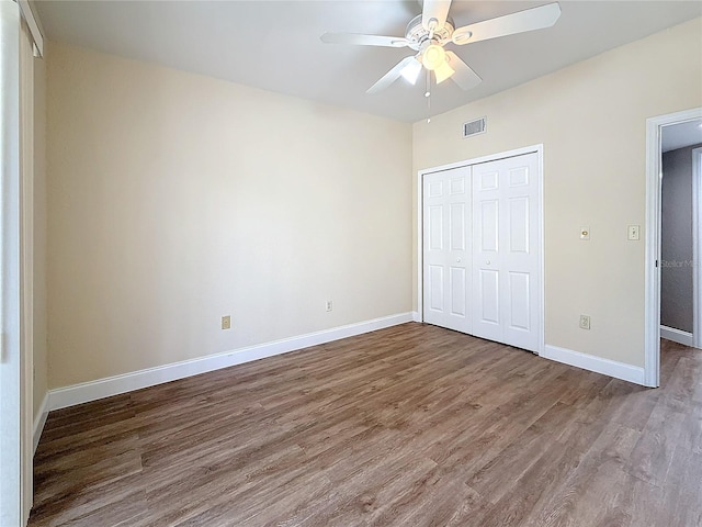 6350 92nd Pl N Unit 2206, Pinellas Park, FL 33782 - unfurnished bedroom featuring wood finished floors, a closet, baseboards, and a ceiling fan