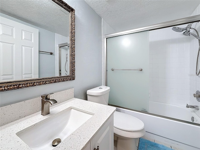 6350 92nd Pl N Unit 2206, Pinellas Park, FL 33782 - full bathroom featuring toilet, vanity, a textured ceiling, and combined bath / shower with glass door