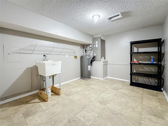 6350 92nd Pl N Unit 2206, Pinellas Park, FL 33782 - laundry area with water heater, a textured ceiling, and heating unit