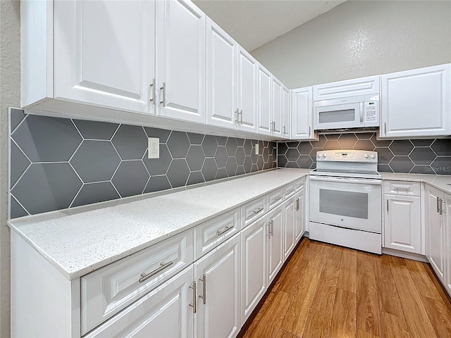 6350 92nd Pl N Unit 2206, Pinellas Park, FL 33782 - kitchen with white appliances, light wood-type flooring, white cabinetry, and decorative backsplash