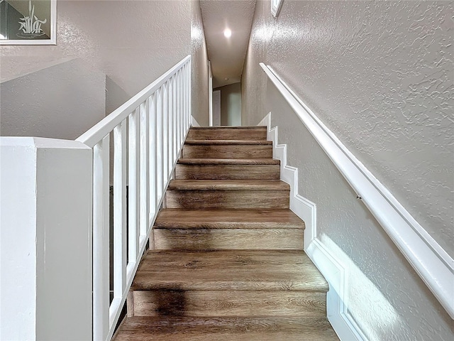 6350 92nd Pl N Unit 2206, Pinellas Park, FL 33782 - staircase featuring a textured wall and wood finished floors