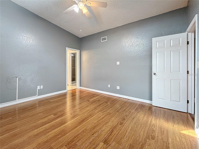 6350 92nd Pl N Unit 2206, Pinellas Park, FL 33782 - unfurnished bedroom with a textured wall, wood finished floors, a textured ceiling, baseboards, and ceiling fan