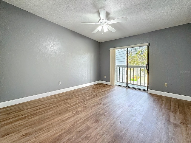 6350 92nd Pl N Unit 2206, Pinellas Park, FL 33782 - spare room with wood finished floors, ceiling fan, a textured ceiling, a textured wall, and baseboards