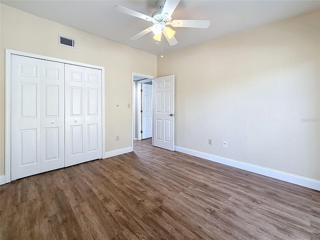 6350 92nd Pl N Unit 2206, Pinellas Park, FL 33782 - unfurnished bedroom featuring dark wood-type flooring, baseboards, a closet, and ceiling fan
