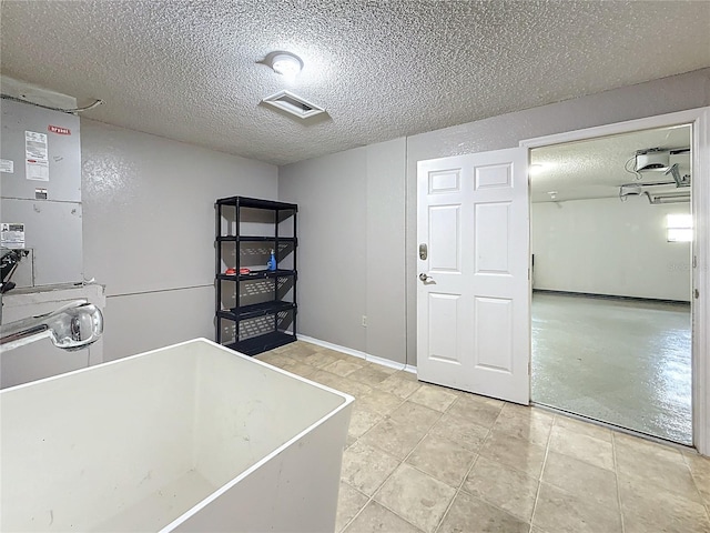 6350 92nd Pl N Unit 2206, Pinellas Park, FL 33782 - laundry room featuring a textured ceiling