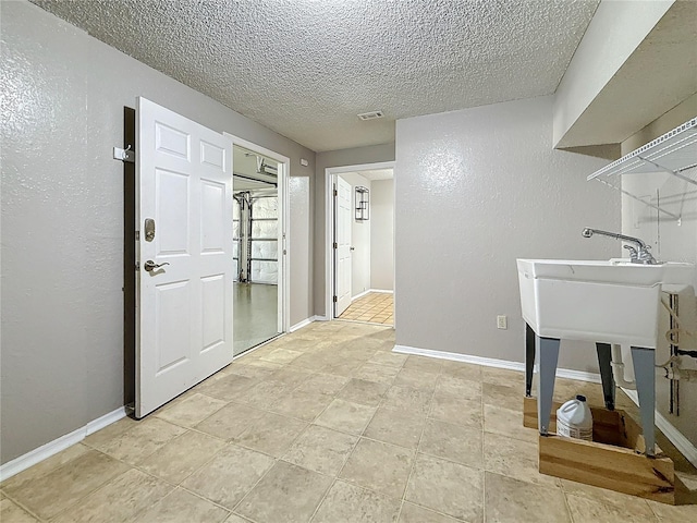 6350 92nd Pl N Unit 2206, Pinellas Park, FL 33782 - washroom featuring a textured ceiling and baseboards