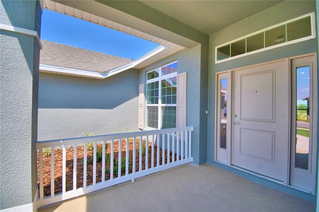 view of exterior entry with stucco siding