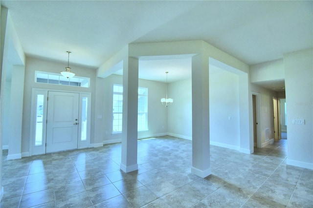 entrance foyer featuring a chandelier, baseboards, and light tile patterned flooring