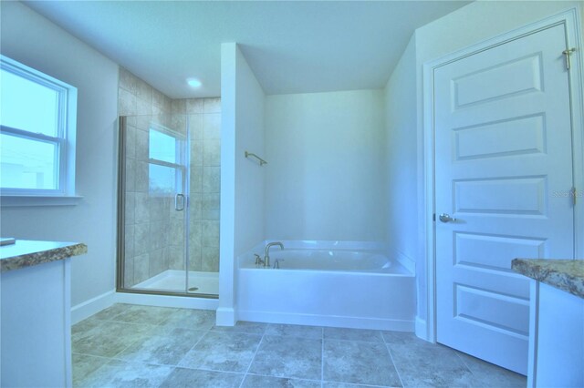 full bathroom with vanity, a stall shower, a bath, and baseboards