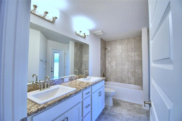 bathroom featuring bathtub / shower combination, a textured ceiling, toilet, and double vanity