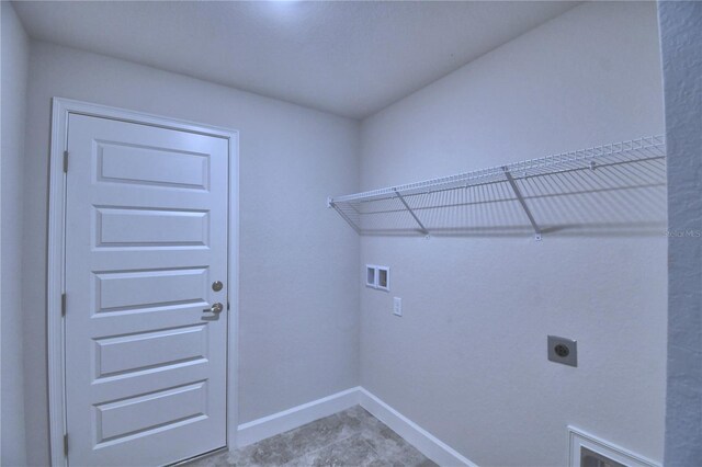 clothes washing area with hookup for an electric dryer, baseboards, hookup for a washing machine, and tile patterned floors