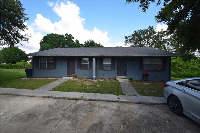6054-6066 Hilltop Ln W, Lakeland, FL 33809 - view of front of house featuring a front yard and a shingled roof