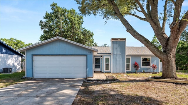 417 Yolonda Ct, Lakeland, FL 33809 - ranch-style house featuring central AC, driveway, an attached garage, a shingled roof, and a chimney