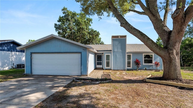 417 Yolonda Ct, Lakeland, FL 33809 - ranch-style house featuring a garage, driveway, a chimney, central AC unit, and a shingled roof