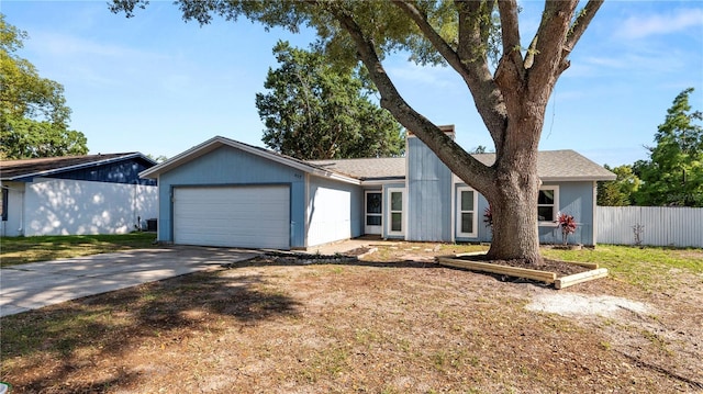 417 Yolonda Ct, Lakeland, FL 33809 - view of front of home with a garage, fence, concrete driveway, and roof with shingles