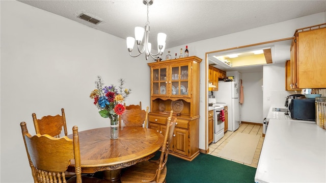 417 Yolonda Ct, Lakeland, FL 33809 - dining area with a chandelier, a textured ceiling, and light tile patterned flooring