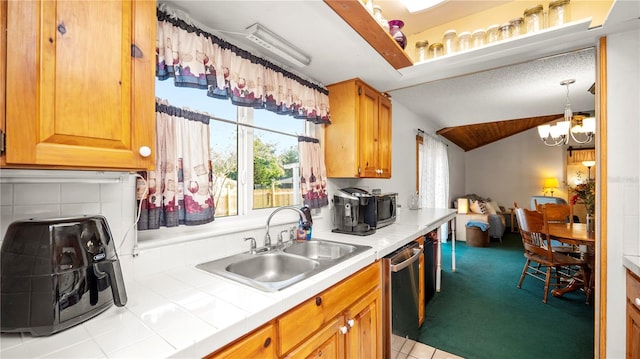 417 Yolonda Ct, Lakeland, FL 33809 - kitchen with a sink, tile countertops, dishwasher, a chandelier, and lofted ceiling