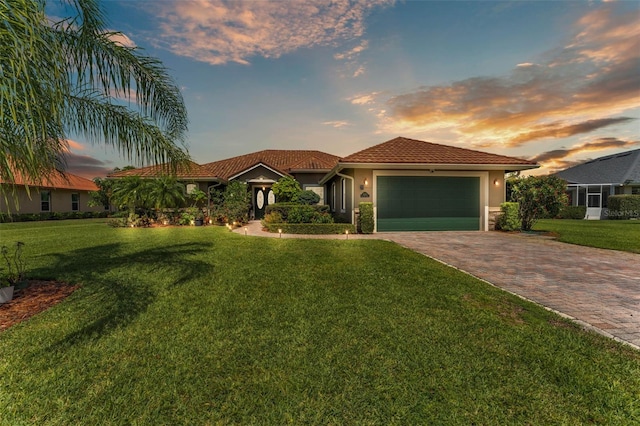 5033 Sugar Bay St, Sebring, FL 33872 - view of front of home featuring decorative driveway, an attached garage, stucco siding, and a lawn