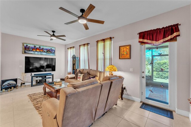 5033 Sugar Bay St, Sebring, FL 33872 - living room with ceiling fan, light tile patterned floors, and baseboards