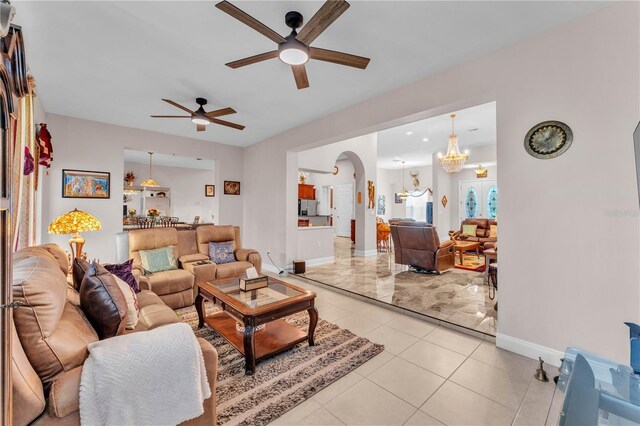 5033 Sugar Bay St, Sebring, FL 33872 - living area featuring a ceiling fan, light tile patterned flooring, baseboards, a chandelier, and arched walkways