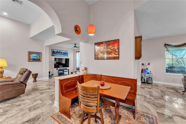 5033 Sugar Bay St, Sebring, FL 33872 - dining area featuring baseboards, light marble finish floors, arched walkways, ceiling fan, and recessed lighting