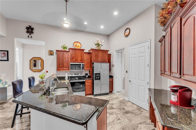 5033 Sugar Bay St, Sebring, FL 33872 - kitchen featuring appliances with stainless steel finishes, a sink, dark stone countertops, a kitchen island with sink, and recessed lighting