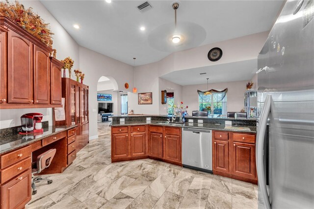5033 Sugar Bay St, Sebring, FL 33872 - kitchen featuring appliances with stainless steel finishes, arched walkways, dark stone countertops, a sink, and pendant lighting