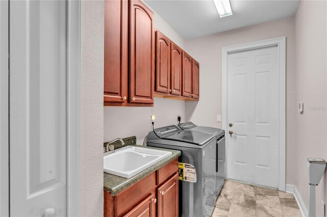 5033 Sugar Bay St, Sebring, FL 33872 - laundry area featuring washer and clothes dryer, cabinet space, and baseboards