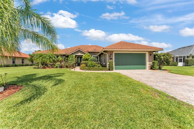 5033 Sugar Bay St, Sebring, FL 33872 - view of front facade featuring driveway, a garage, stucco siding, a tiled roof, and a front lawn