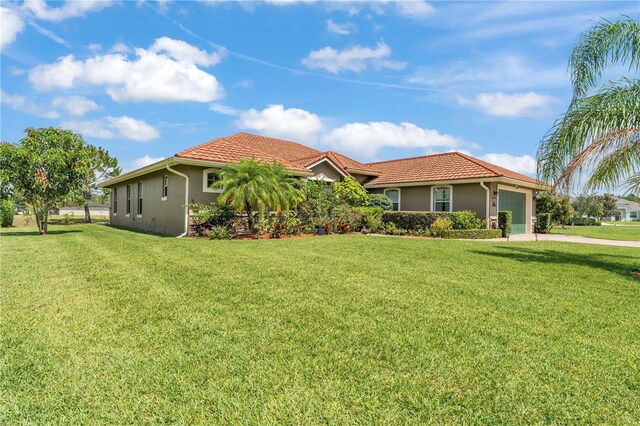 5033 Sugar Bay St, Sebring, FL 33872 - mediterranean / spanish-style home with a garage, stucco siding, a front yard, and a tiled roof